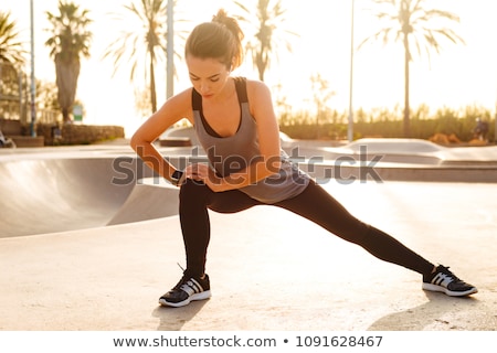 Stok fotoğraf: Sports Woman In Park Outdoors Make Sport Stretching Exercises