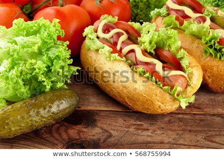 Сток-фото: Hot Dogs With Lettucetomatoes And Cucumber On Tray On Wooden Board