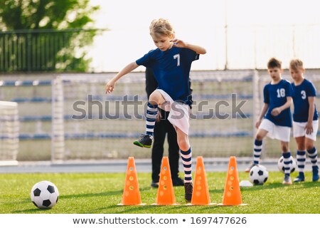 Boy Jumping Over Soccer Cones On Football Training Field Kids O ストックフォト © matimix