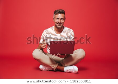 Сток-фото: Image Of Excited Man In Striped T Shirt Smiling While Holding Cr