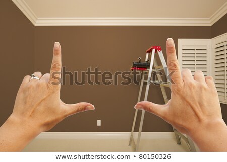 [[stock_photo]]: Female Hands Framing Empty Room Of House