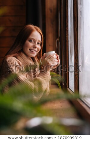 Сток-фото: Portrait Of Cosy Young Girl Standing Near A Window At Home