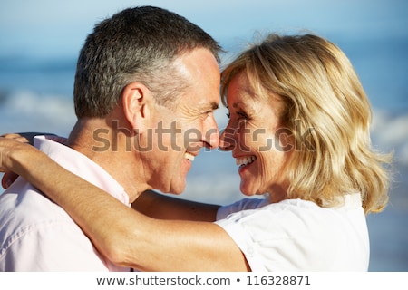 Stockfoto: Older Couple Hugging On A Beach
