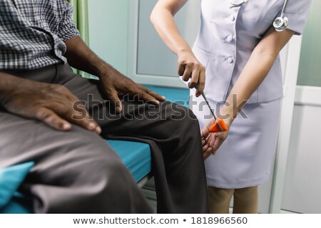 Stockfoto: A Nurse Testing Reflexes Of A Patient