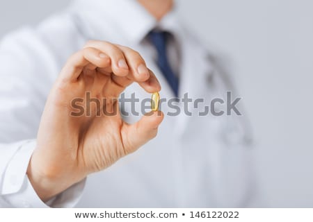 Stok fotoğraf: Male Doctor Holding Capsule