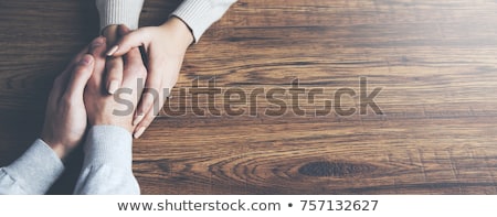 [[stock_photo]]: Couple Holding Hands By Table