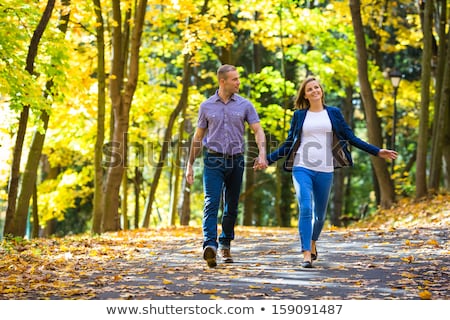 Stok fotoğraf: Lovers Is Running With Hold Hands On City Park