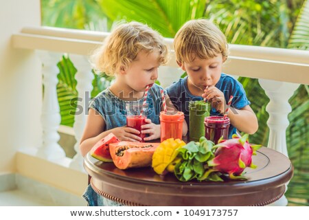 ストックフォト: Children Drink Colorful Healthy Smoothies Watermelon Papaya Mango Spinach And Dragon Fruit Smo