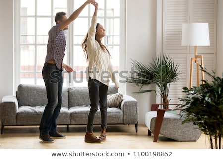 Foto stock: Romantic Young Couple Dancing Together In Living Room