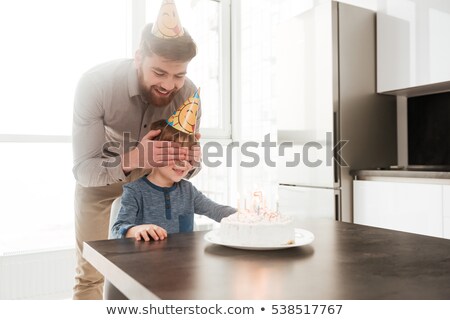 Zdjęcia stock: Bearded Father In Kitchen With Birthday Son Covering His Eyes