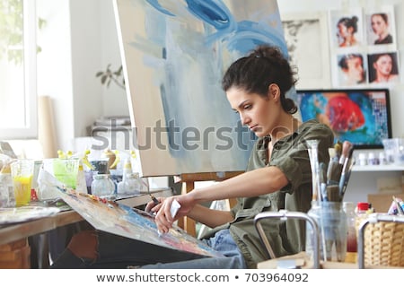 Foto stock: Woman Painting On Canvas In Drawing Class