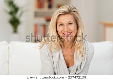 Foto stock: Beautiful Blonde Woman Relaxing At Home Smiling