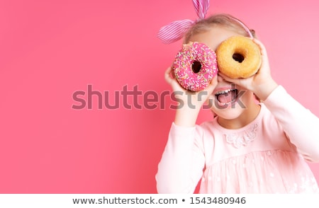 [[stock_photo]]: Portrait Of A Satisfied Young Woman Showing Pastry