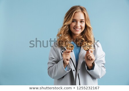 Stock photo: Image Of Blonde Woman 20s Wearing Raincoat Smiling And Holding C