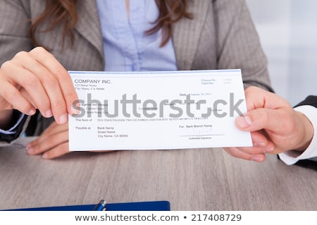 Foto d'archivio: Businesswoman Checking Bill Over Desk