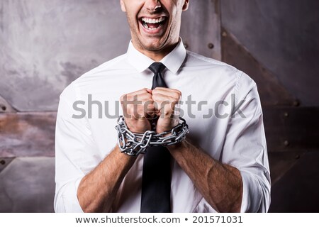 Stockfoto: Hands Of Man Tied Up With Chain