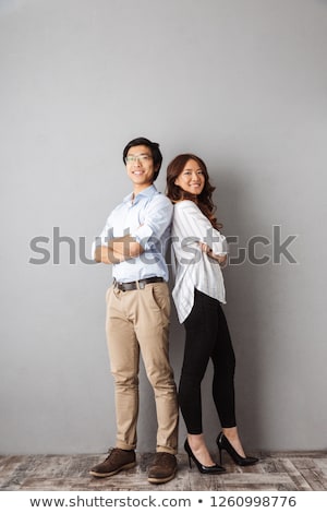 Foto d'archivio: Full Length Portrait Of A Young Happy Asian Man On Gray Background