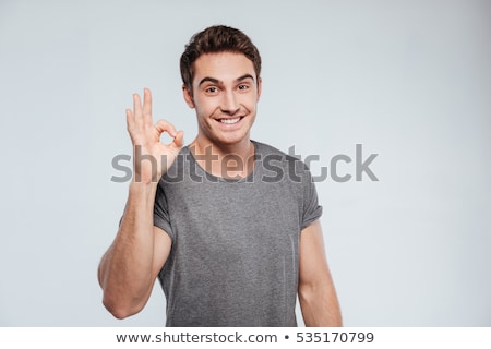 Foto stock: Smiling Man Showing Ok Hand Sign