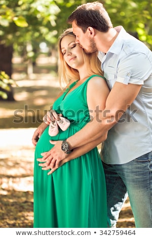 Stock foto: Portrait Of A Cute Expectant Parents In Park