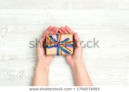 Stok fotoğraf: Female Hands Holding Gay Pride Awareness Ribbon