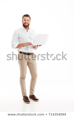Stok fotoğraf: Handsome Young Bearded Man Standing Isolated Over White Wall Background Holding Clipboard