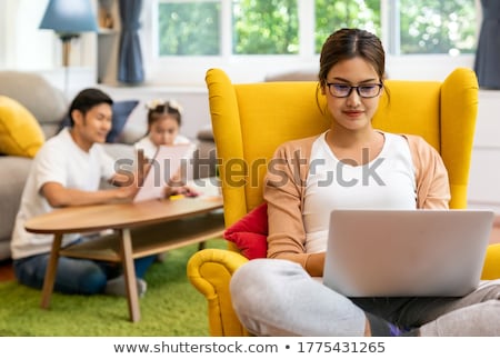 [[stock_photo]]: Mom Reading Story To Daugther While Dad Work From Home