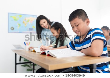 Stock foto: Young Chinese Boy With Homework For School