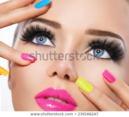 Foto stock: Womans Face With Vivid Make Up And Colorful Nail Polish