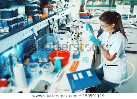 Foto stock: Scientists Researching In Laboratory In White Lab Coat Gloves A