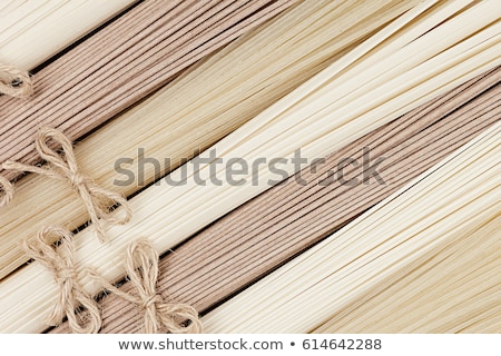 Foto stock: Decorative Border Of Assortment Raw Asian Noodles On Soft Beige Wooden Board With Copy Space Top Vi