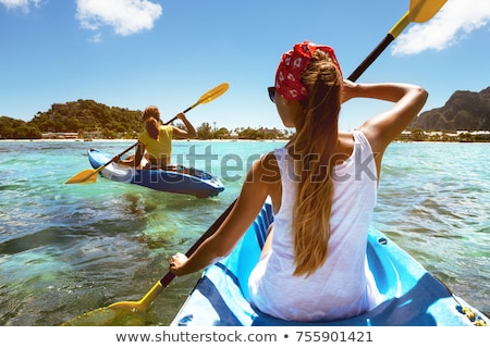 Foto stock: Young Woman Sea Kayaking