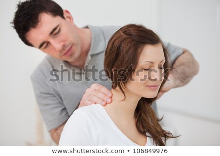 Stock photo: Woman Sitting While Being Massaged By A Man In Room