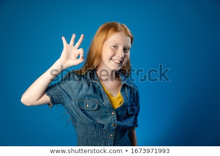 Foto d'archivio: Happy Red Haired Teenage Girl Showing Ok Hand Sign