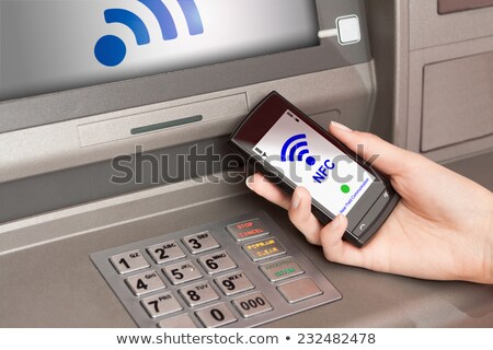 Foto d'archivio: Withdrawing Money Atm With Mobile Phone A Nfc Terminal