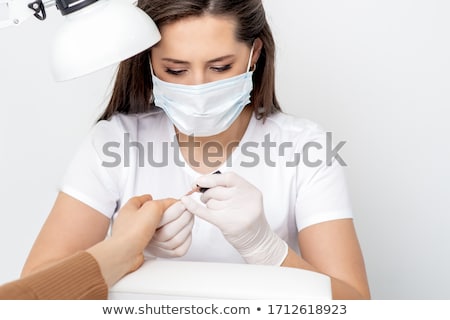 Stockfoto: Manicurist Painting A Customers Nails