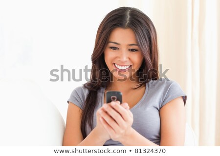 Stok fotoğraf: Cheerful Charming Woman Lying And Talking On Cell Phone