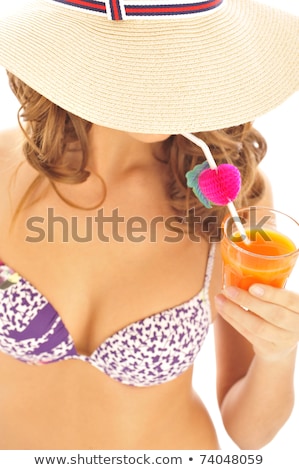 Foto d'archivio: Young Pretty Brunette Woman Wearing Summer Hat And Swimsuit Isolated On White Background Preparing T