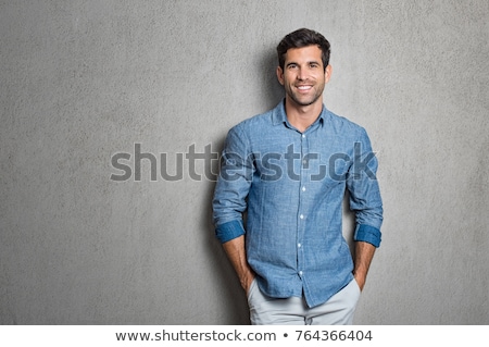 [[stock_photo]]: Handsome Business Man Leaning On A Grey Wall
