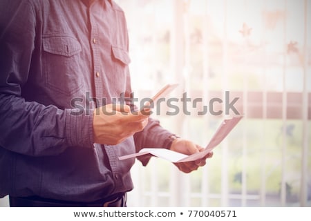 ストックフォト: Man Calculating Bills On Mobile Phone