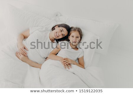 Stock photo: Top View Of Happy Mother And Daughter Awake In Good Mood Feel Relaxed Enjoy Comfort In Bed Rejoic