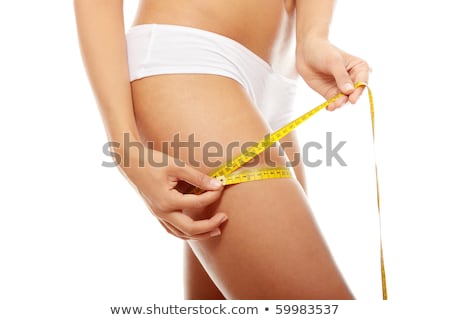 Сток-фото: Woman Measuring Her Thigh With A White Metric Tape