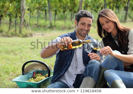 Сток-фото: Couple Tasting Wine In Field