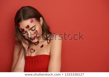 Zdjęcia stock: Glamorous Woman Looking Down While Wearing A Red Dress