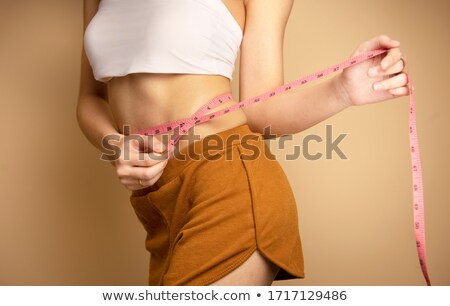 Stock photo: Asian Woman Measuring Body Losing Weight