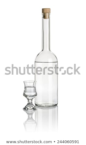 Stok fotoğraf: Liquor Bottle And Glass Goblet Filled With Clear Liquid