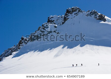 Stok fotoğraf: Silhouetted Ski Tourers On The Mountain