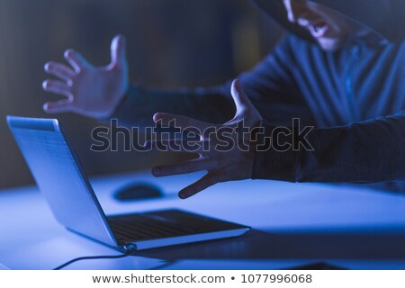 Stok fotoğraf: Angry Hacker With Laptop Shouting In Dark Room