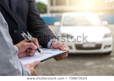 Stock foto: Insurance Agent Examine Damaged Car And Filing Report Claim Form
