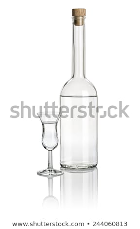 Stock fotó: Liquor Bottle And High Stem Glass Filled With Clear Liquid