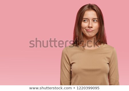 Foto stock: Portrait Of A Confused Young Woman Dressed In Jacket